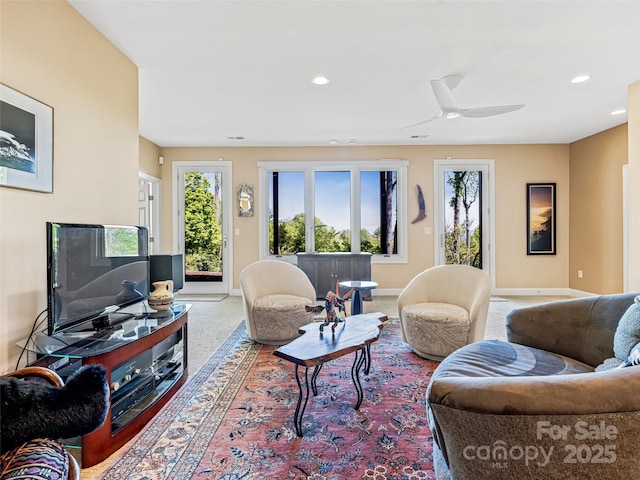 living area featuring baseboards, carpet flooring, ceiling fan, and recessed lighting