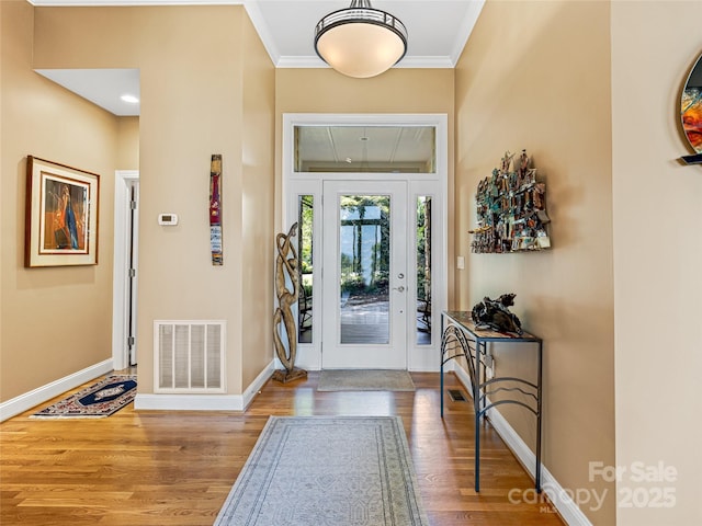 543 Hagen Dr, Hendersonville, NC 28739 - entryway featuring baseboards, visible vents, ornamental molding, and wood finished floors