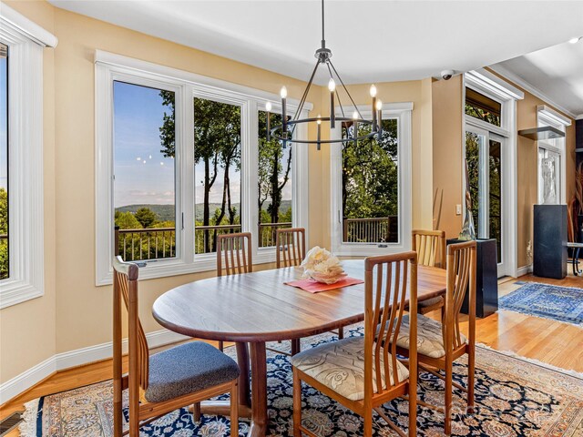 543 Hagen Dr, Hendersonville, NC 28739 - dining area with light wood-type flooring, baseboards, a chandelier, and a wealth of natural light