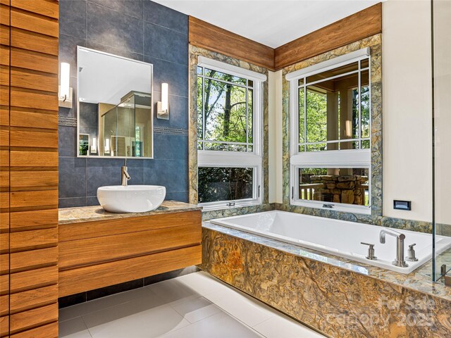 543 Hagen Dr, Hendersonville, NC 28739 - full bath featuring tile patterned floors, tile walls, a bath, and vanity