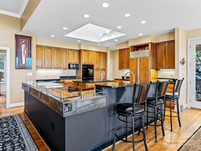 543 Hagen Dr, Hendersonville, NC 28739 - kitchen featuring black microwave, baseboards, light wood finished floors, and a spacious island