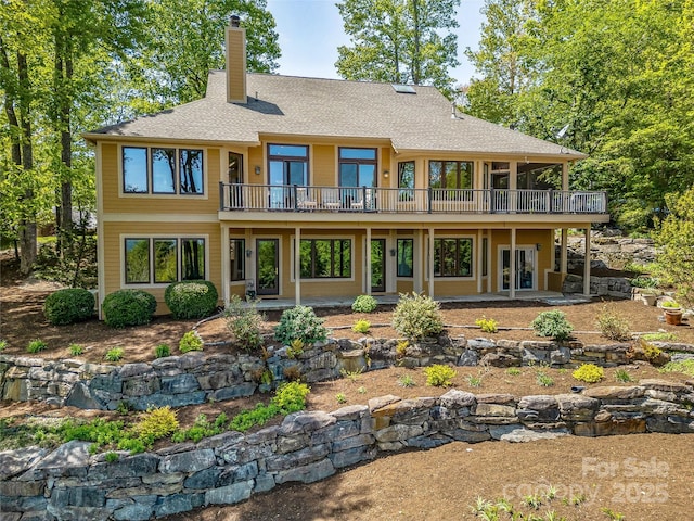 543 Hagen Dr, Hendersonville, NC 28739 - back of house featuring roof with shingles, a wooden deck, a chimney, and a patio area