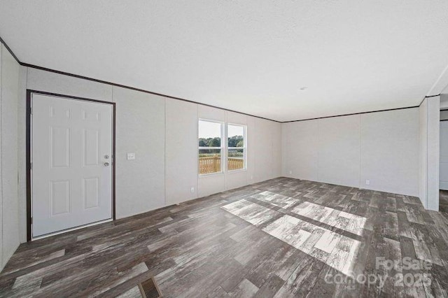 unfurnished living room featuring wood finished floors