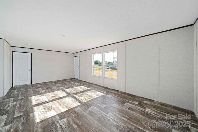 spare room featuring wood finished floors