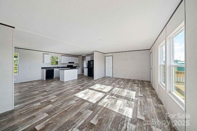 unfurnished living room with wood finished floors