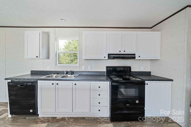 kitchen with dark countertops, range hood, and black appliances