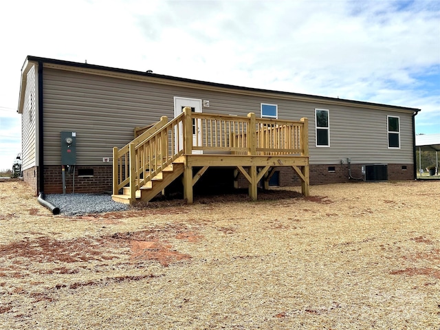 back of house featuring stairway, crawl space, cooling unit, and a wooden deck