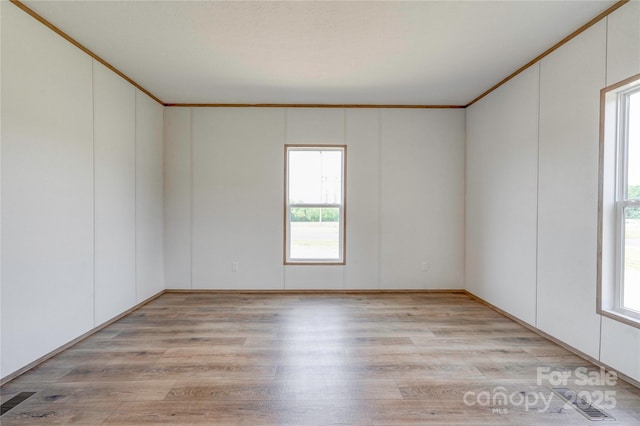 445 Davis Rd, Shelby, NC 28152 - empty room featuring light wood-style floors, visible vents, and plenty of natural light