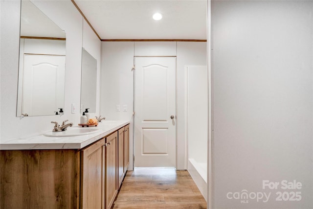 445 Davis Rd, Shelby, NC 28152 - bathroom with recessed lighting, ornamental molding, a sink, double vanity, and wood finished floors