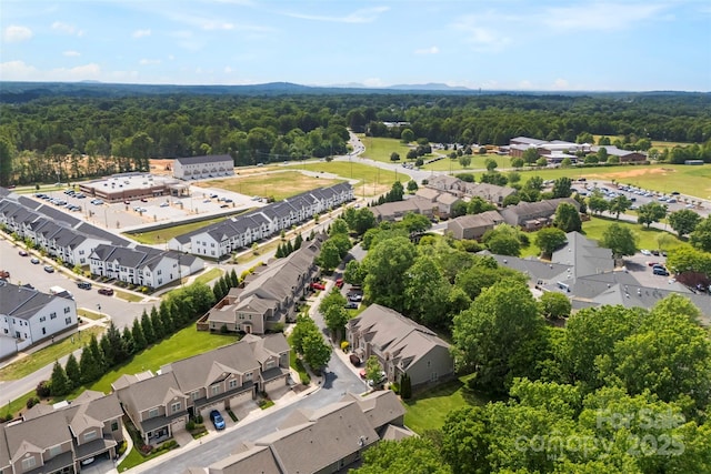 birds eye view of property with a view of trees