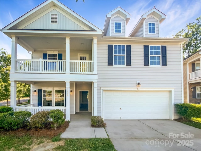 view of front facade with an attached garage, concrete driveway, a balcony, and covered porch