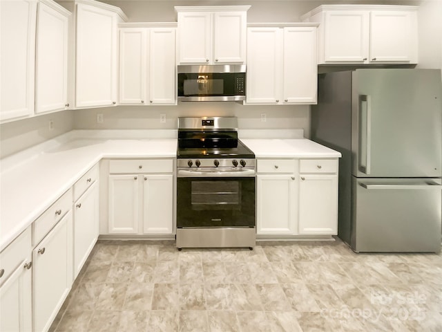kitchen with light countertops, white cabinetry, and appliances with stainless steel finishes