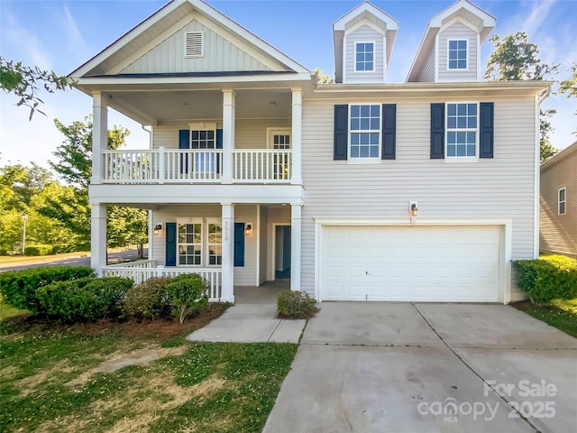 view of front of house with covered porch, board and batten siding, a garage, a balcony, and concrete driveway