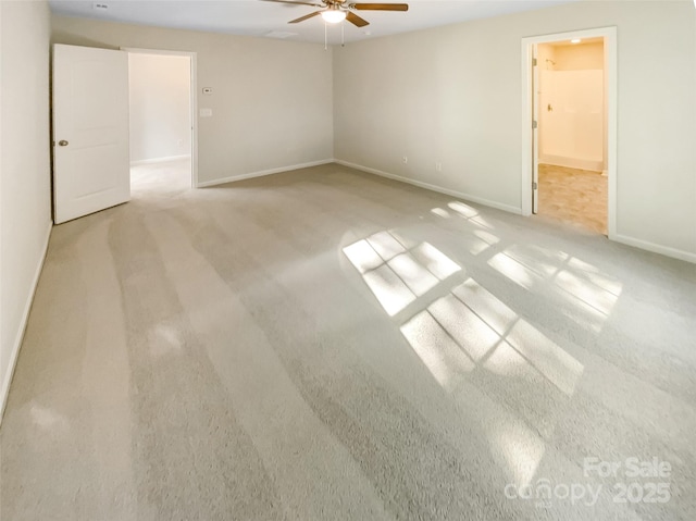 spare room featuring carpet floors, baseboards, and ceiling fan