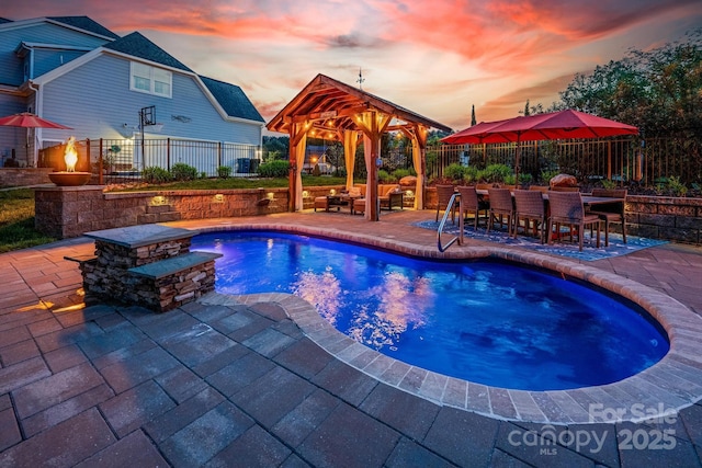 view of swimming pool with a fenced backyard, a gazebo, outdoor dry bar, and a patio area