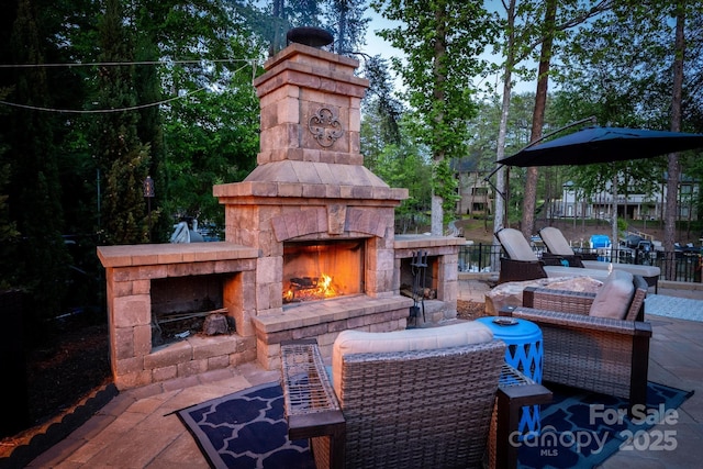 view of patio featuring an outdoor stone fireplace