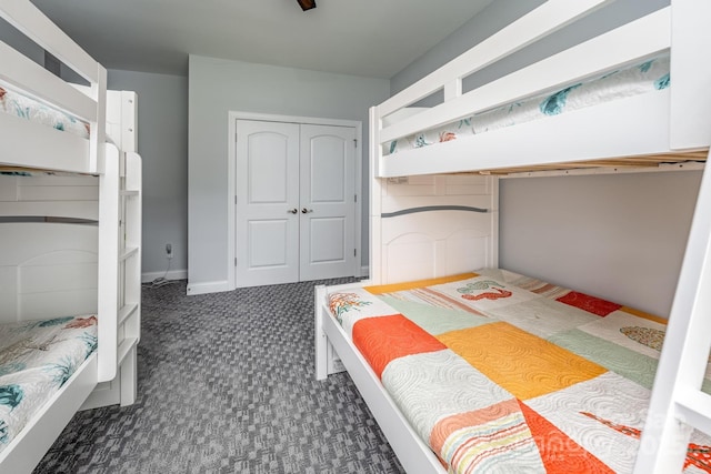 bedroom featuring a closet and dark carpet