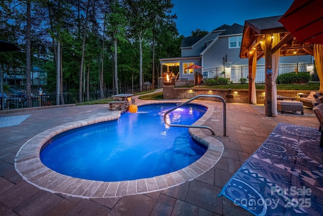 view of swimming pool featuring a fenced in pool, fence, and a patio area
