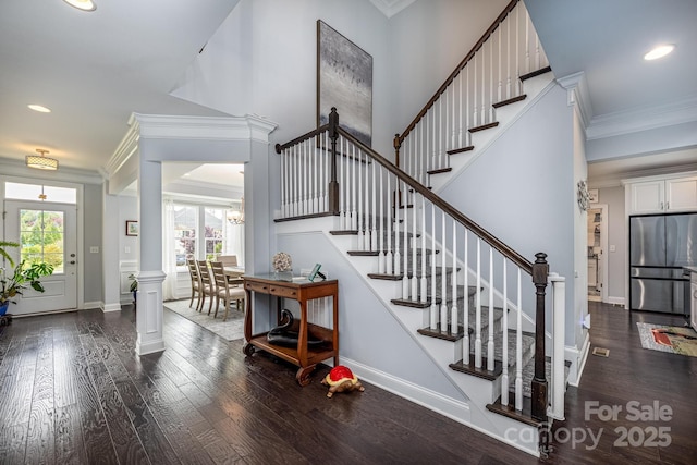 stairway featuring wood-type flooring, ornamental molding, baseboards, and recessed lighting