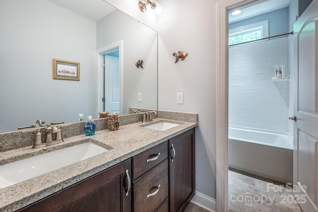 bathroom featuring a sink, baseboards, double vanity, and tub / shower combination