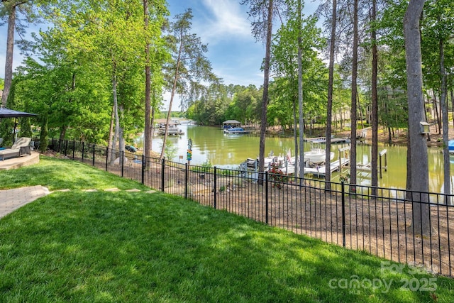 water view featuring a boat dock, fence, and boat lift