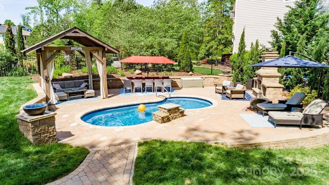 pool featuring an outdoor living space, fence, a patio, and a gazebo