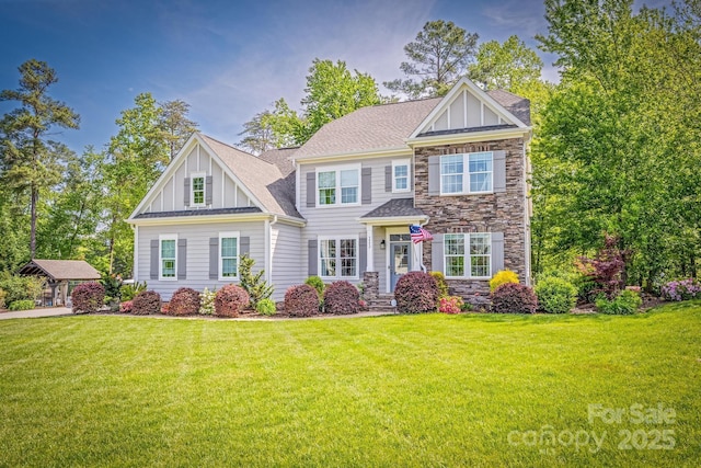 view of front of home featuring a front lawn, board and batten siding, roof with shingles, and stone siding