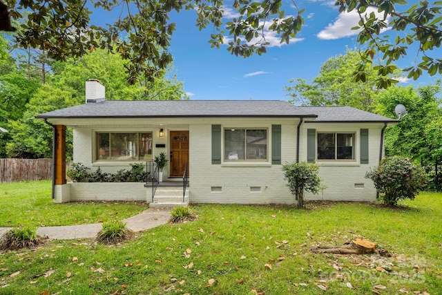 view of front of property with crawl space, a chimney, brick siding, fence, and a front lawn