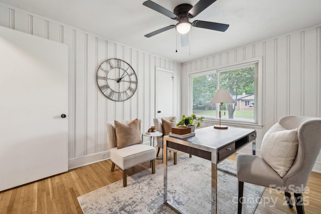 home office with baseboards, light wood finished floors, and ceiling fan