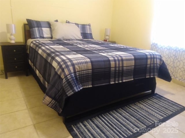 bedroom with light tile patterned floors