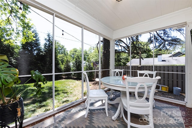 sunroom with outdoor dining area