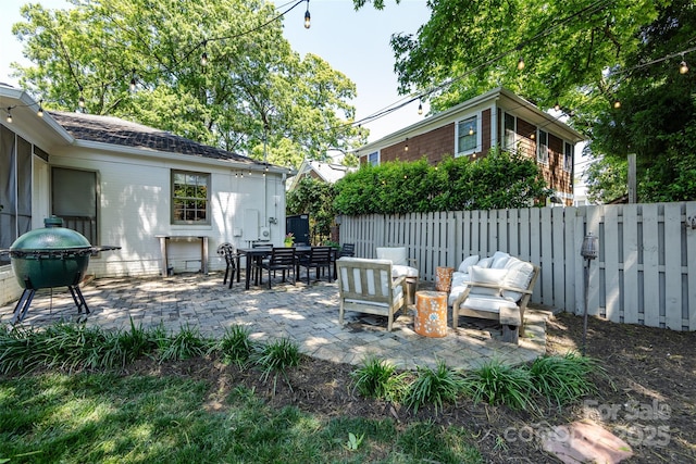 view of patio / terrace with fence, area for grilling, and an outdoor living space