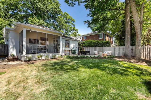rear view of property featuring a sunroom