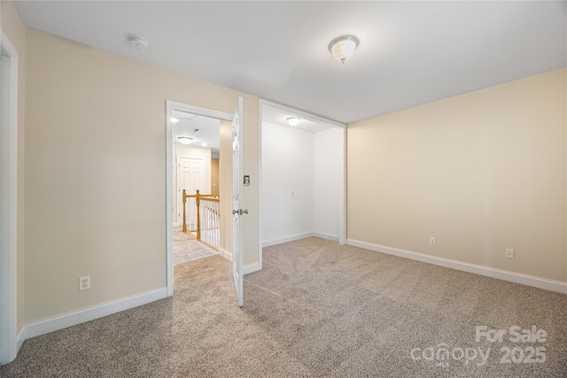 unfurnished bedroom featuring carpet and baseboards