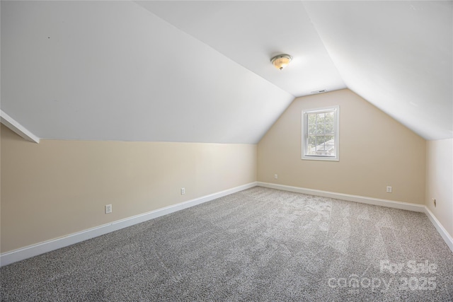 additional living space featuring lofted ceiling, carpet floors, and baseboards