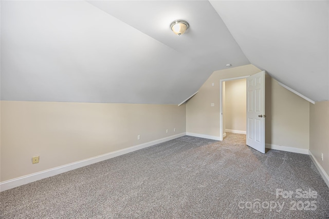 bonus room with vaulted ceiling, carpet floors, and baseboards