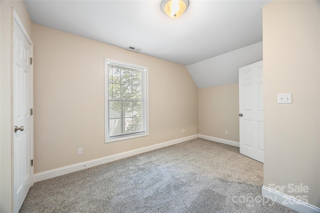 additional living space with carpet floors, baseboards, and lofted ceiling
