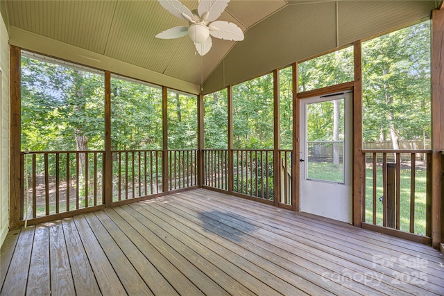 unfurnished sunroom with a ceiling fan and vaulted ceiling