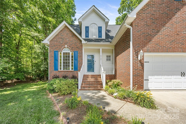 view of front of property with an attached garage, brick siding, a front yard, and concrete driveway