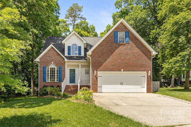 traditional home with driveway, a front yard, a garage, and brick siding