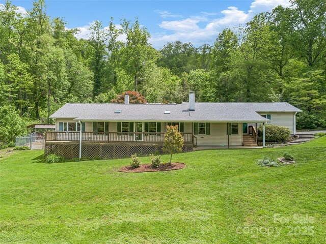 128 Summer Haven Rd, Swannanoa, NC 28778 - view of front of property featuring a front lawn, a chimney, a deck, and a wooded view