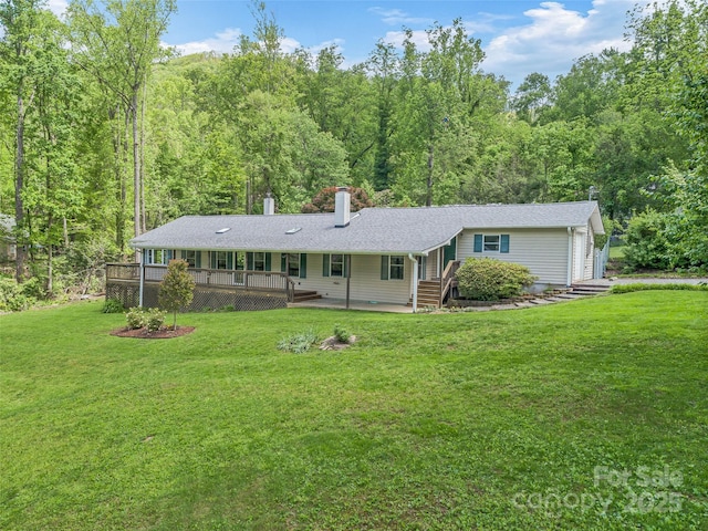 128 Summer Haven Rd, Swannanoa, NC 28778 - single story home with a chimney, a front lawn, a forest view, and a wooden deck