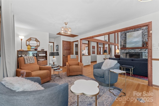 living area with wood finished floors and a fireplace