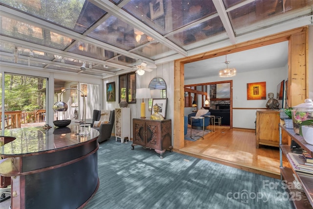 reception area featuring ceiling fan with notable chandelier