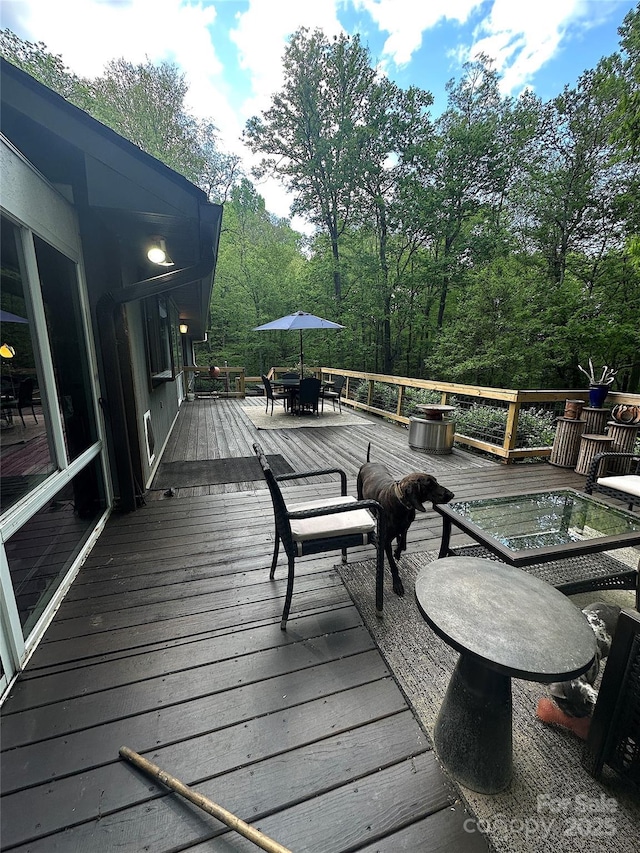 wooden deck featuring outdoor dining area