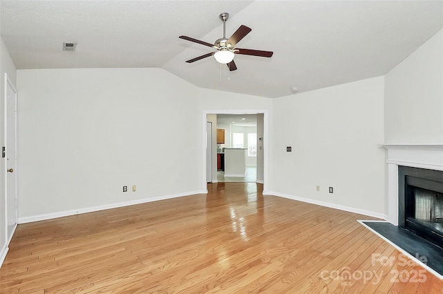 9232 Four Mile Creek Rd, Charlotte, NC 28277 - unfurnished living room with a fireplace, baseboards, ceiling fan, light wood finished floors, and vaulted ceiling