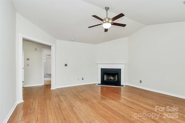 9232 Four Mile Creek Rd, Charlotte, NC 28277 - unfurnished living room with ceiling fan, light wood finished floors, baseboards, a fireplace with flush hearth, and vaulted ceiling