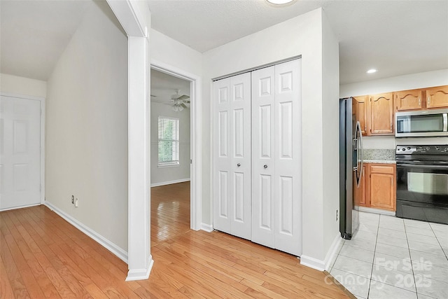 9232 Four Mile Creek Rd, Charlotte, NC 28277 - kitchen featuring light countertops, ceiling fan, light wood-style floors, and stainless steel appliances