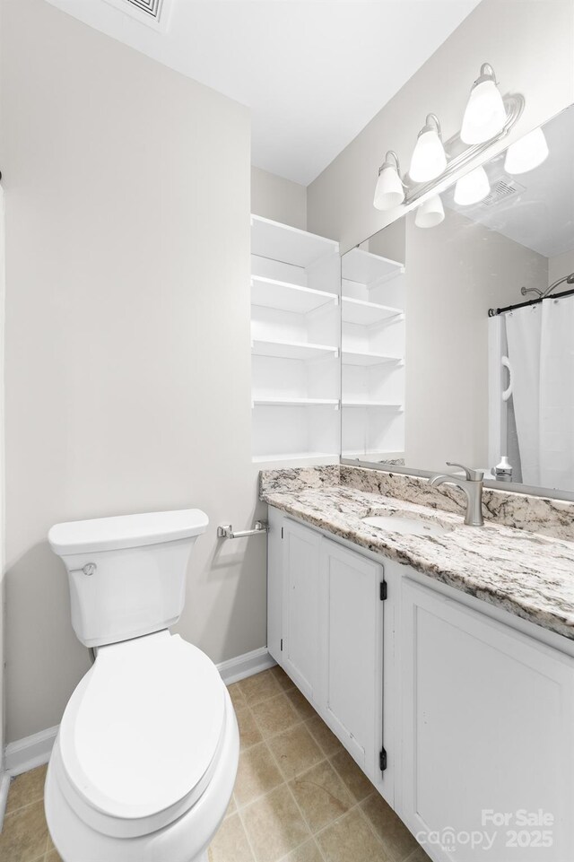 full bathroom with vanity, baseboards, and toilet