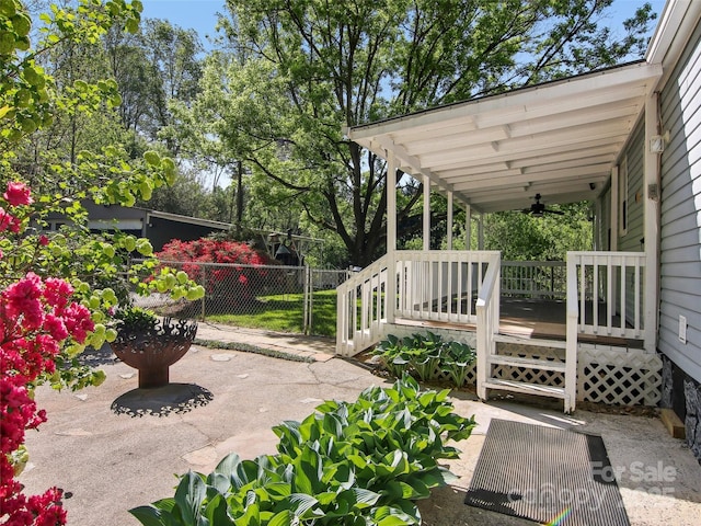 view of patio featuring a ceiling fan and fence